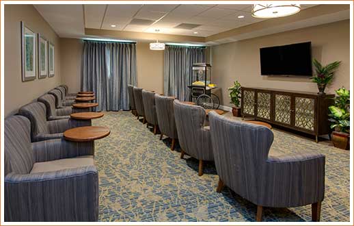 Interior of entertainment room. Large TV with comfortable chairs in rows.