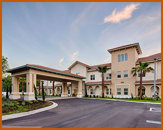 A welcoming stucco building with a large circular drive